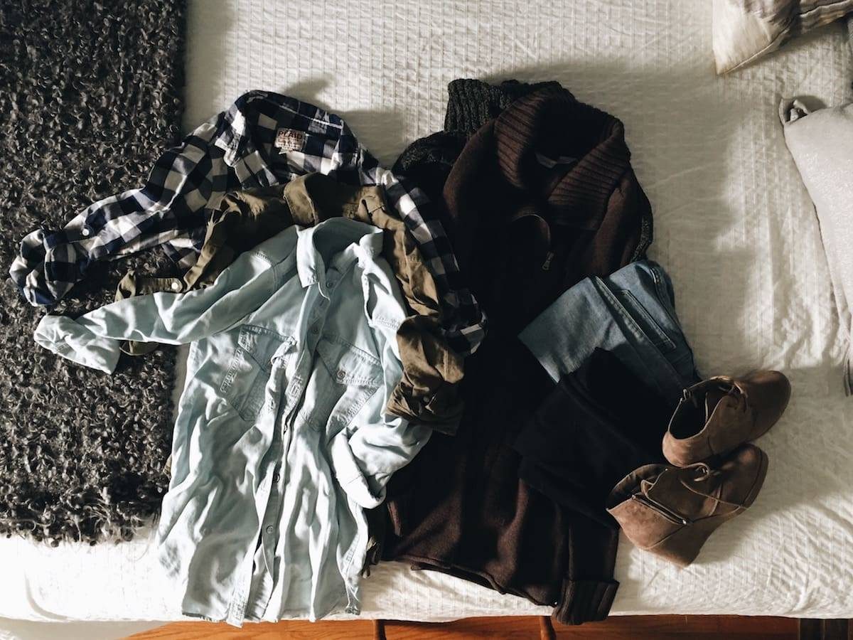 clothes laying out on a bed