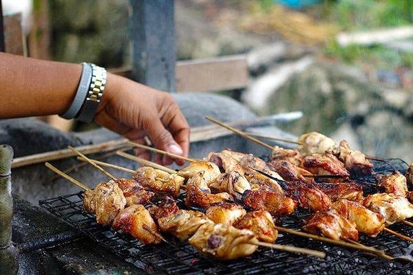 Filipino chicken barbecue on a grill.