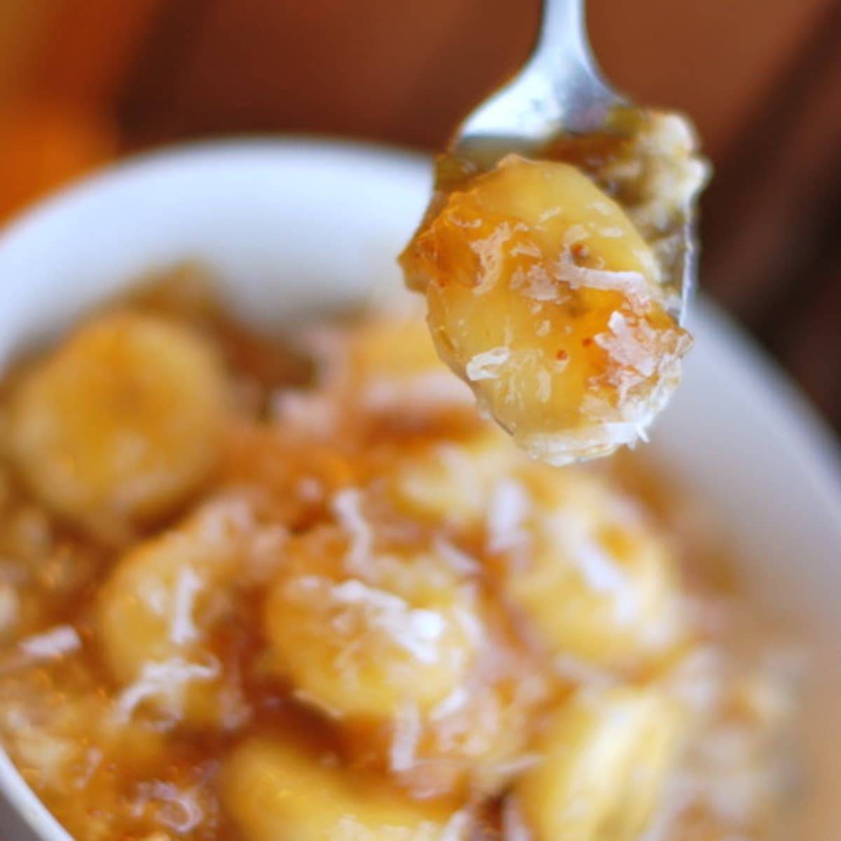 Caramelized banana and fig oatmeal on a spoon.