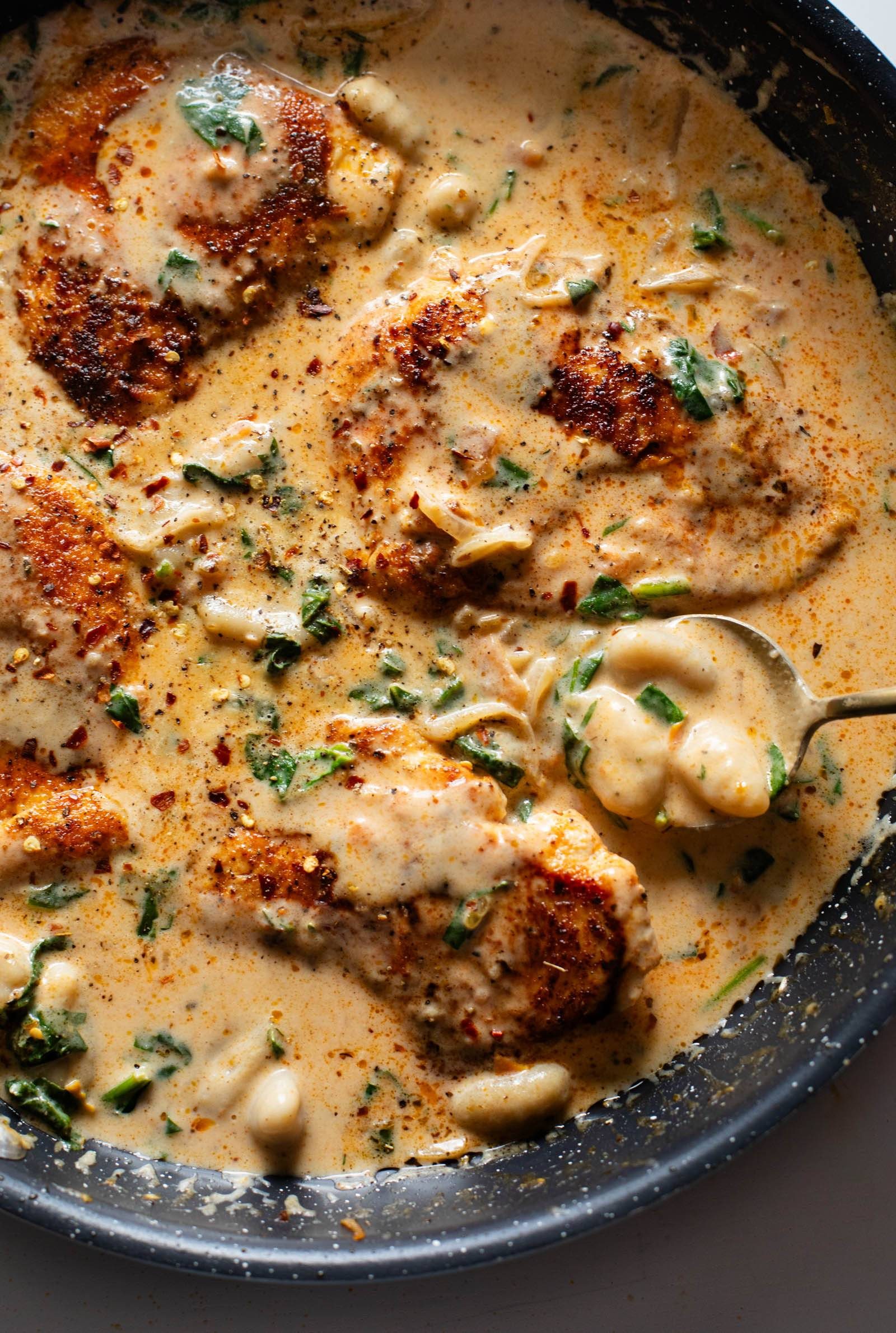 Creamy chicken and gnocchi in a skillet.