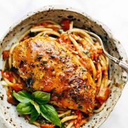 Garlic Basil Chicken in a bowl with pasta and basil.