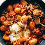 Gnocchi with red sauce and ricotta in a bowl.