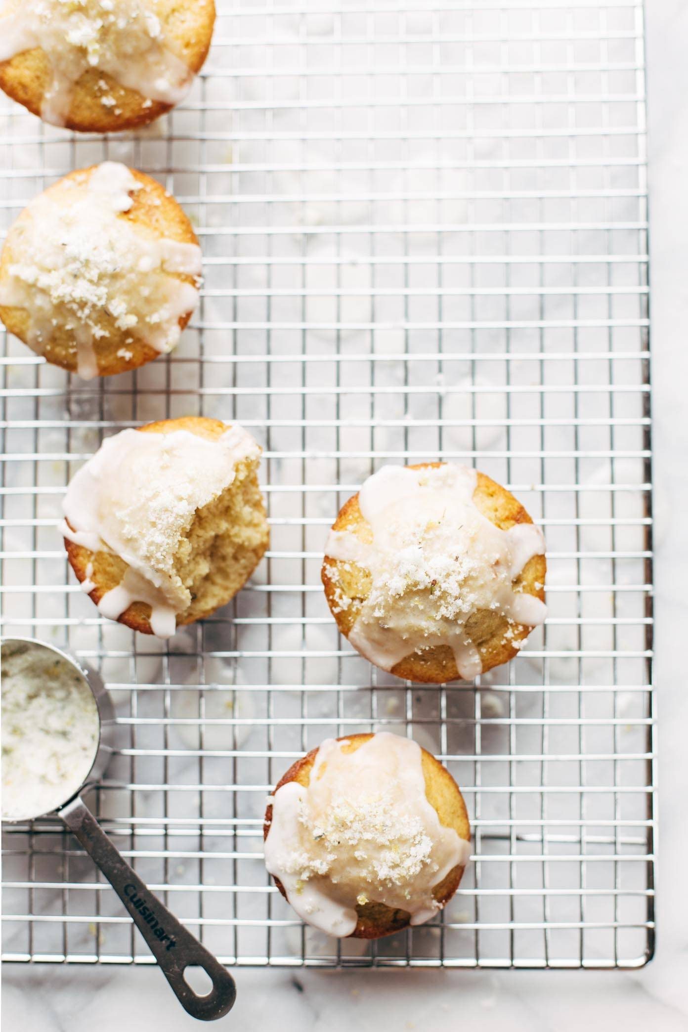 Lemon Lavender Muffins on a drying rack with a measuring cup