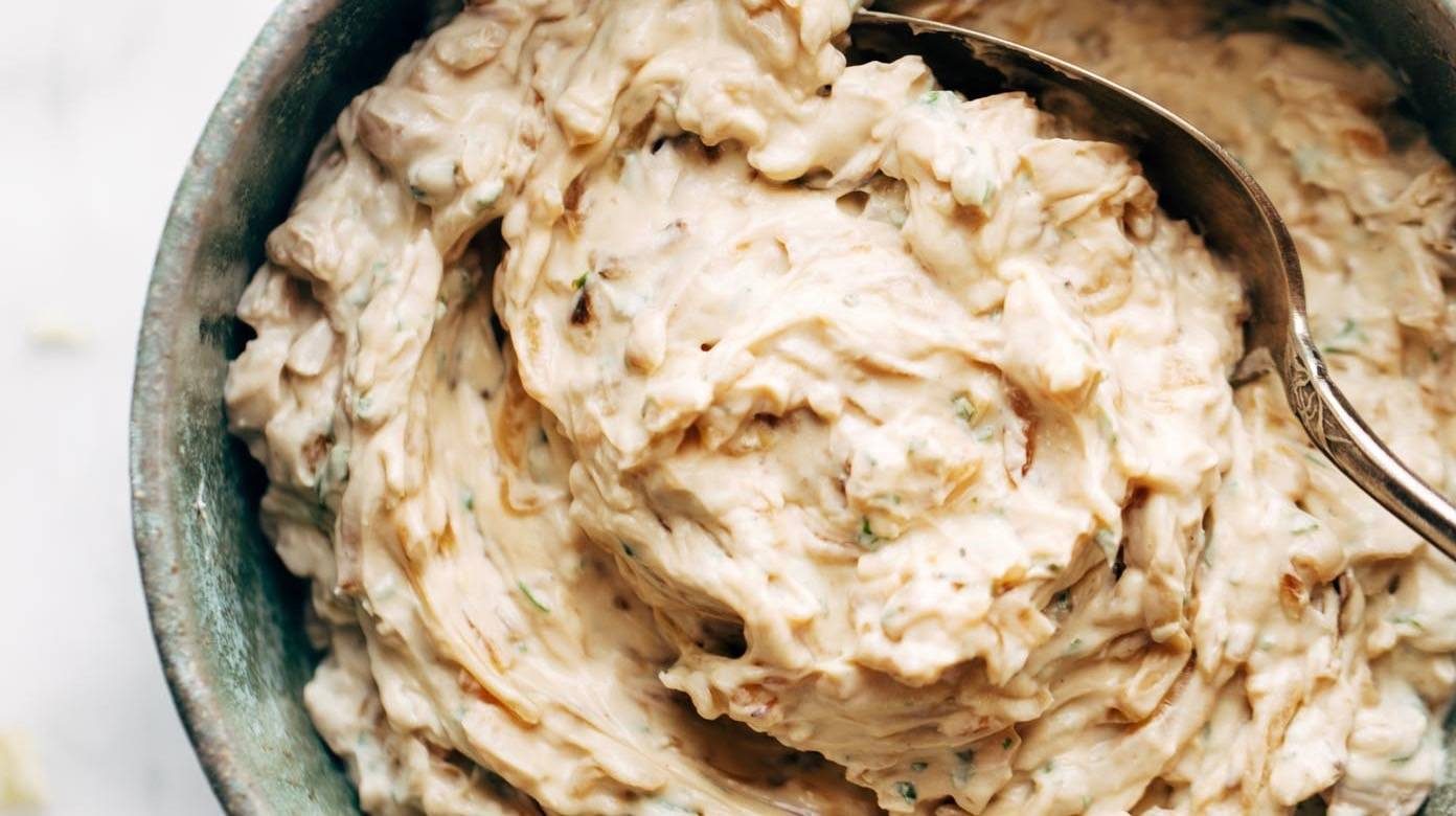 A large rustic bowl of onion dip.